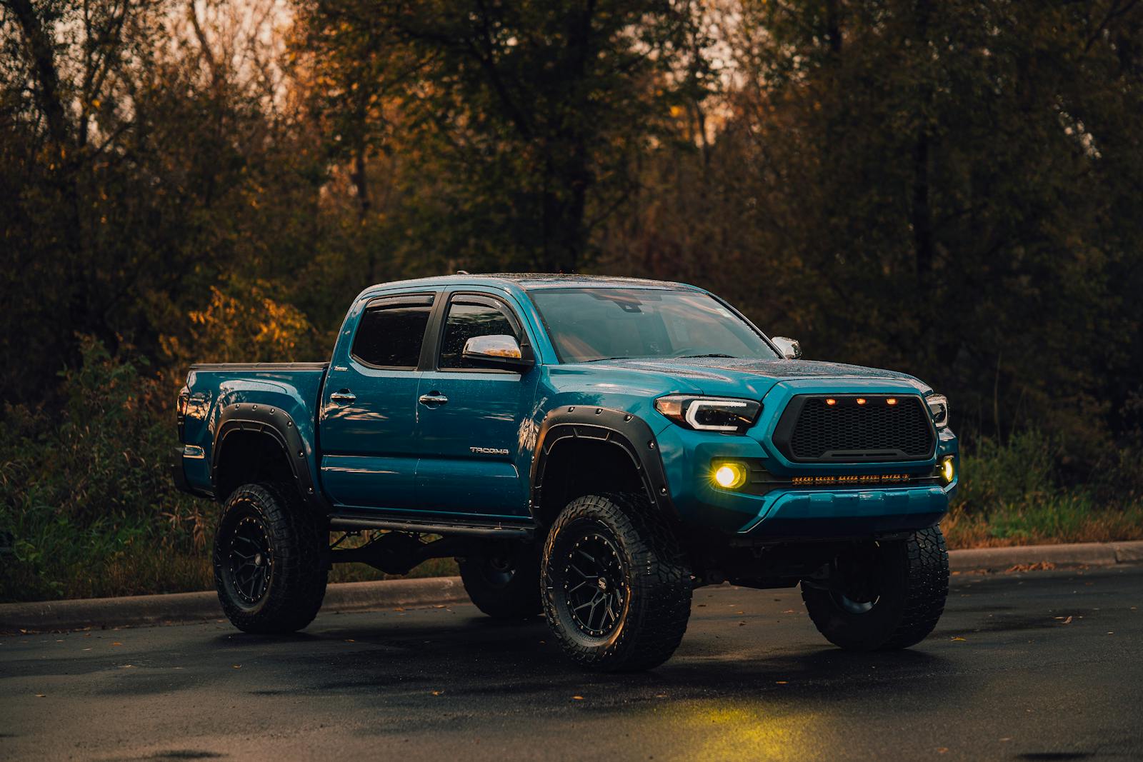 Lifted Toyota Tacoma with custom wheels and off-road tires